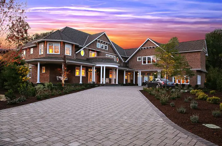 A large house with a driveway and lots of landscaping.