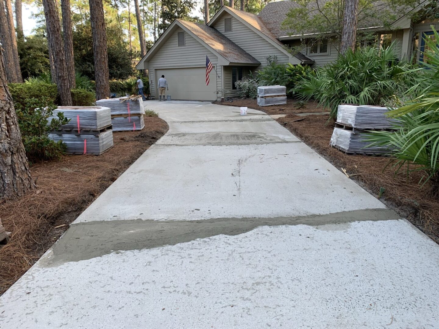 A driveway with concrete and cement blocks in the middle of it.