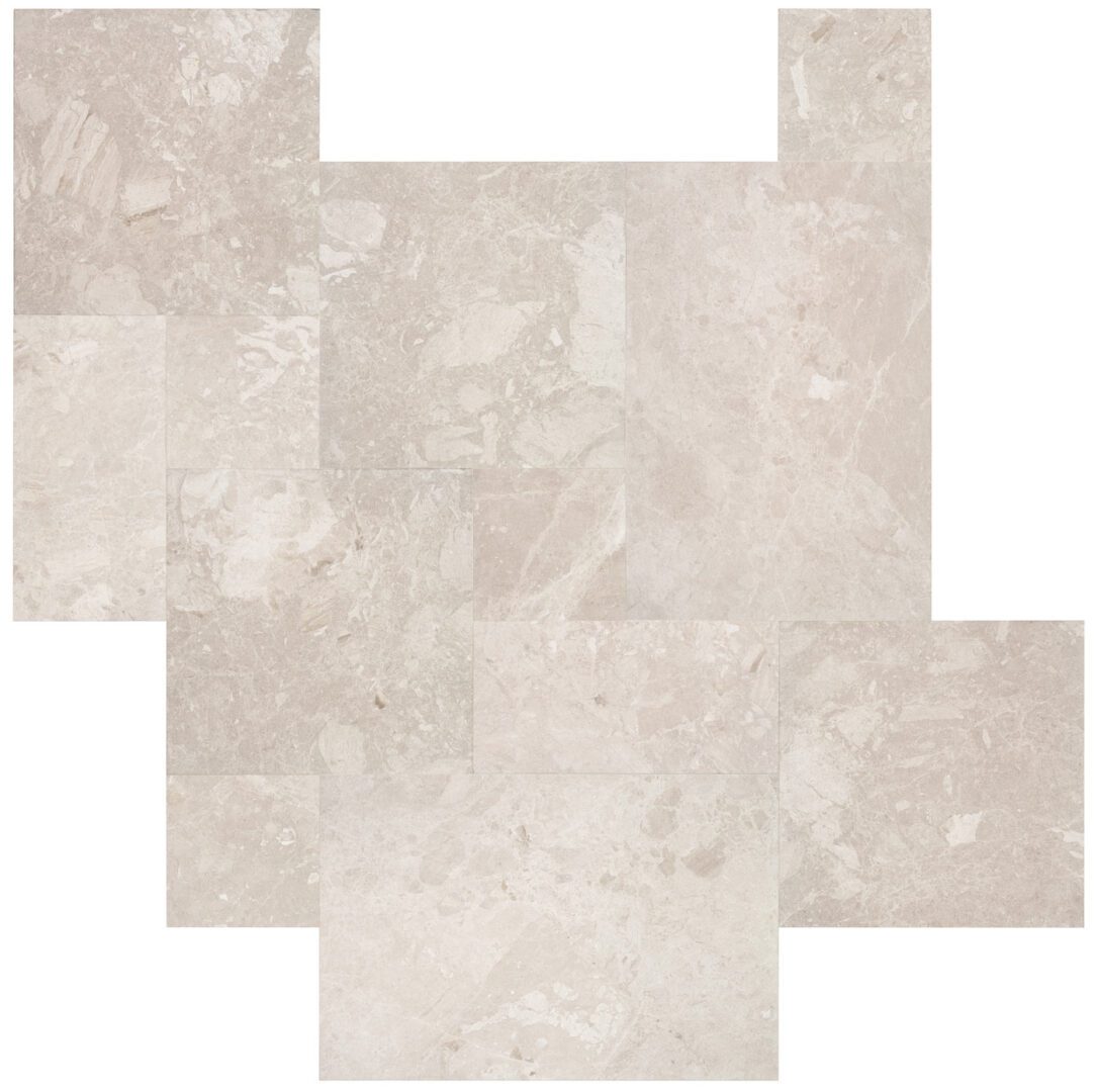 Rectangular light beige marble tiles arranged in a herringbone pattern.