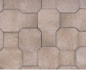 Close-up of a beige and light brown paver stone pattern consisting of alternating octagonal and square tiles.